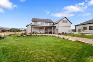 View of front facade with a patio area and a front yard