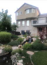 Rear view of house featuring a balcony