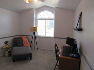 Office area with light colored carpet, lofted ceiling, and ceiling fan