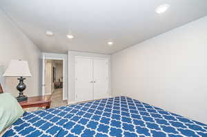 Bedroom featuring a closet, a textured ceiling, and carpet floors