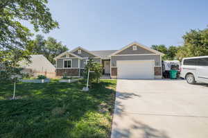 View of front of property with a garage and a front yard