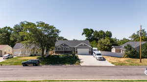 Single story home with a garage and a front yard