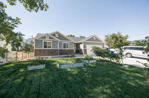 Craftsman-style house with a garage and a front yard