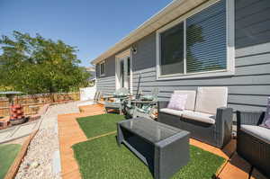 Exterior space with an outdoor hangout area and a wooden deck