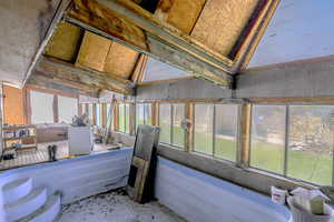 Sunroom featuring vaulted ceiling