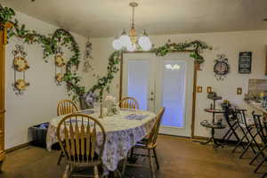 Dining room with a textured ceiling and a chandelier