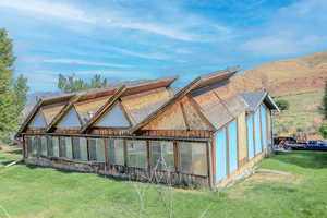 Exterior space with a mountain view and a lawn