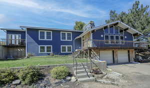 View of front of house featuring a front yard and a garage