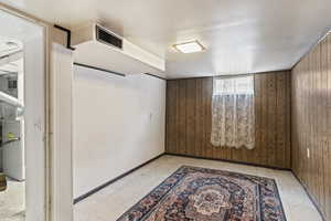 Basement featuring wooden walls