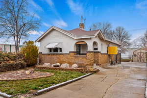 View of front of home with a storage shed