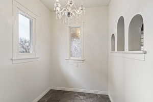 Unfurnished dining area with an inviting chandelier