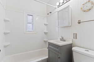 Full bathroom with toilet, shower / washtub combination, and vanity