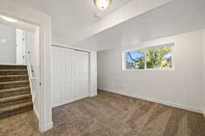 Unfurnished bedroom featuring a textured ceiling, a closet, and carpet floors