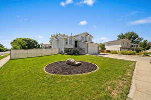 View of front of property with a front lawn and a garage