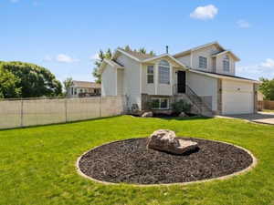 View of front of property with a front lawn and a garage