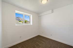 Empty room with carpet flooring and a mountain view