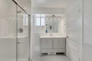 Primary Bathroom featuring vanity and a shower with shower door