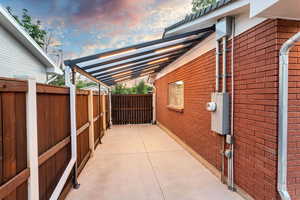 Carport / awning with lighting. Total depth is 28 feet. Width is 9 feet. Length of covered area is 18 ft.