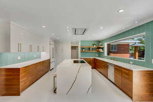 Kitchen featuring quartz countertops, walnut cabinets, flush mount hood and a 10 ft picture window