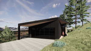 Garage featuring a mountain view and a yard