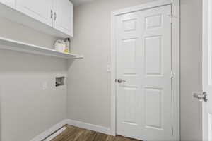 Washroom featuring hookup for a washing/dryer and cabinets