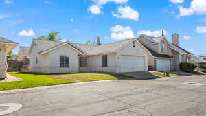 View of front of property with a garage and a front lawn.