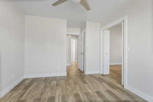 Unfurnished bedroom with ceiling fan, and a closet