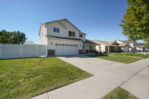 View of front of property with a garage and a front yard