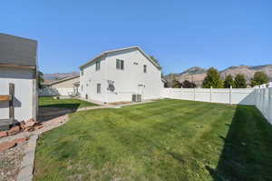 View of yard with central AC unit and a mountain view