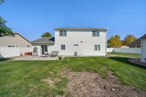 Back of property featuring a yard and a patio