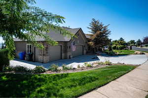 View of property exterior with a yard, 3 car garage and RV parking