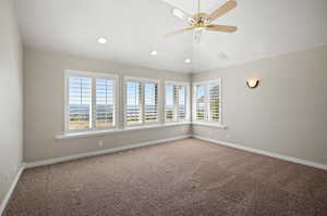 Master Bedroom with view, carpet and vaulted ceiling.