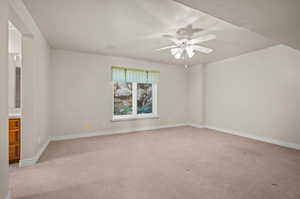 3rd bedroom with Jack and Jill bath.  light carpet, a textured ceiling, and ceiling fan