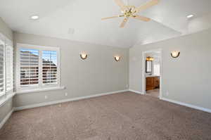 Primary Bedroom featuring light carpet, lofted ceiling, amazing view, ceiling fan