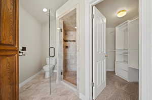 Master Bathroom with a shower with door and toilet