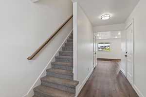 Staircase featuring hardwood / wood-style floors