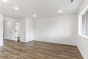 Empty room with hardwood / wood-style flooring