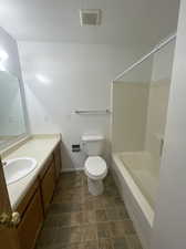 Full bathroom featuring vanity, toilet, and washtub / shower combination