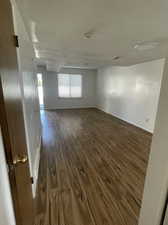 Family room featuring a textured ceiling and dark hardwood / wood-style flooring