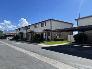 View of front of property featuring a mountain viewshowing front door and covered parking space.