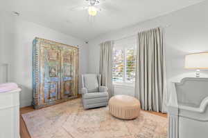 Nursery sitting room featuring hardwood / wood-style floors and ceiling fan