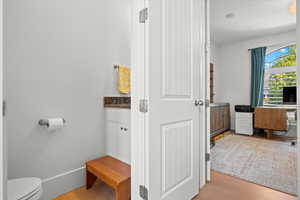 Bathroom with hardwood / wood-style floors and toilet