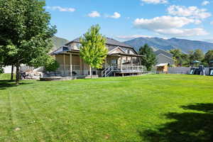 View of back yard featuring a mountain view and a sunroom