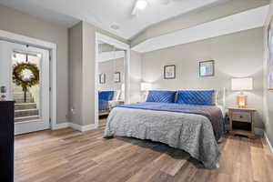 Bedroom featuring hardwood / wood-style flooring, access to outside, ceiling fan, and a closet