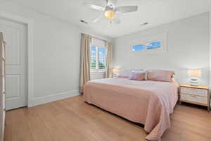 Bedroom with ceiling fan and light hardwood / wood-style flooring