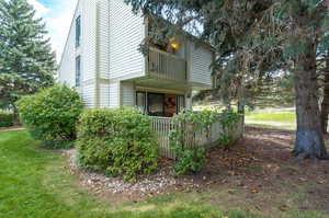 Exterior space with a balcony and a front lawn