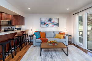 Living room with light hardwood / wood-style floors