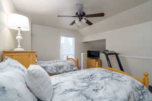 Bedroom with ceiling fan and vaulted ceiling