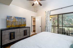 Bedroom featuring hardwood / wood-style flooring, access to exterior, and ceiling fan