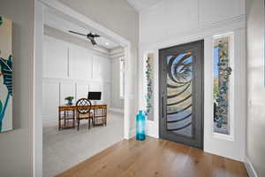 Foyer entrance with light wood-type flooring and ceiling fan